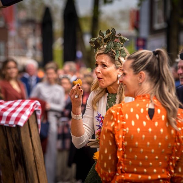 Koningin Maxima eet een Argentijnse kroket tijdens Koningsdag in Emmen