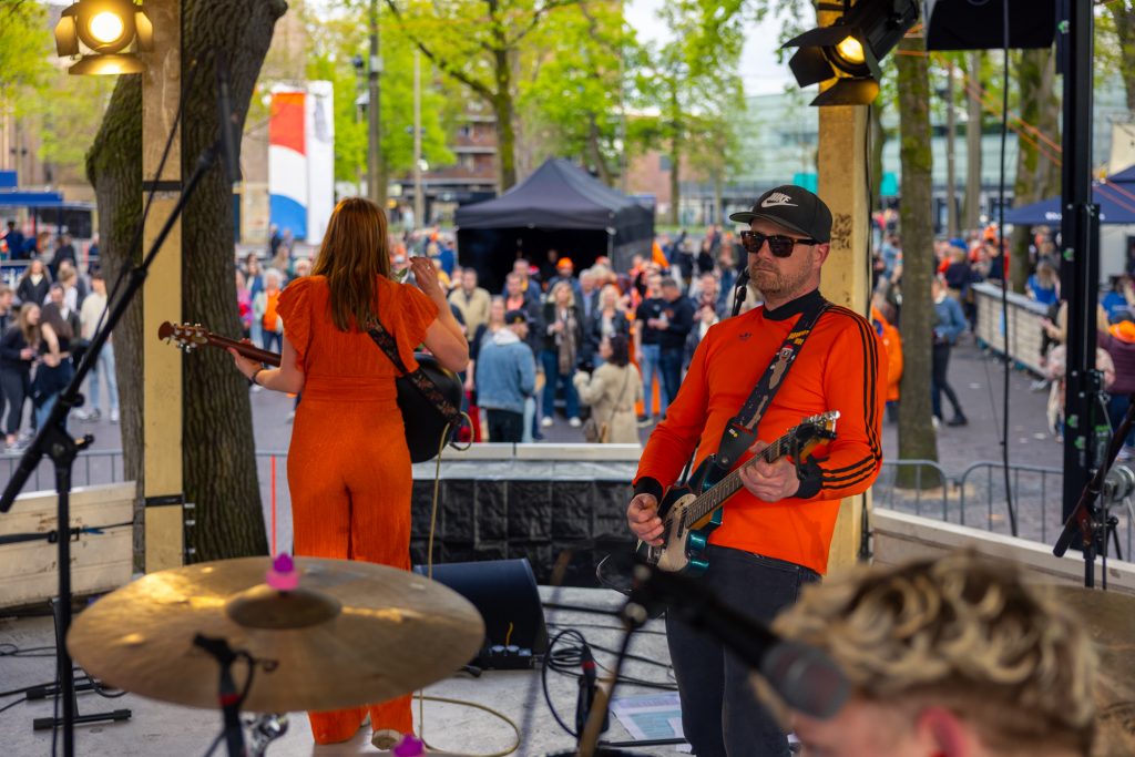 Bandje speelt in oranjekleding bij de Muziekkoepel in Emmen tijdens Koningsdag